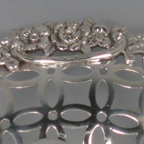 Antique Victorian sterling silver dish, having hand-pierced decoration with swags and bows, with a cast foliate border, and sitting on a matching cast foliate foot. Made by William Comyns of London in 1894. The dimensions of this fine hand-made silver table dish are length 36 cms (14.25 inches), width 28 cms (11 inches), height 10 cms (4 inches), and it weighs approx. 25 troy ounces (775g).