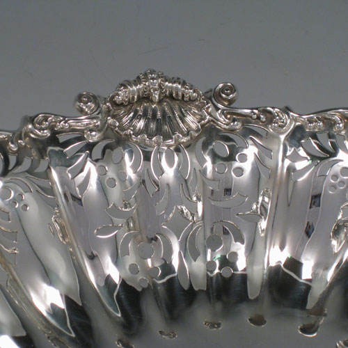 Antique Victorian sterling silver fine oval dish with fluted and hand-perced decoration, cast shell and foliate border, and cast shell feet. Made by Turner Bradbury of London in 1894. The dimensions of this fine hand-made table dish are height 11.5 cms (4.5 inches), length 34 cms (13.5 inches), width 24 cms (9.5 inches), and it weighs approx. 30 troy ounces (930g).