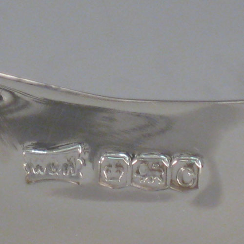 A very pretty Antique Sterling silver dish, having a plain rounded semi-triangular shaped body with central dimple, a hand-cut shaped and pierced border, and sitting on three pierced foliate feet with central strengthening ring. This beautiful silver raised dish was made by Walker and Hall of Sheffield in 1920. The dimensions of this fine hand-made antique silver dish are height 14 cms (5.5 inches), width 21 cms (8.25 inches), and it weighs approx. 520g (16.8 troy ounces). 