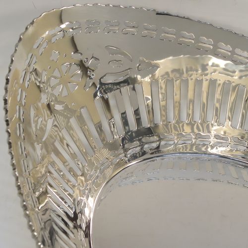 A very pretty Antique Sterling Silver bread roll table dish, having an oval body with hand-pierced geometrical and floral style decoration, an applied gadroon top border, and sitting on a flat base. This beautiful antique silver bread roll dish was made by the Barker Brothers of Chester in 1911. The dimensions of this fine hand-made silver bread dish are length 30 cms (11.75 inches), width 17.5 cms (7 inches), height 7.5 cms (3 inches), and it weighs approx. 389g (12.5 troy ounces).   