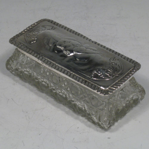 Antique Victorian sterling silver hand-chased and cut-crystal dressing table box made by the Deakin Brothers of Chester in 1901. Length 11 cms (4.25 inches), width 5 cms (2 inches), height 4.5 cms (1.75 inches).