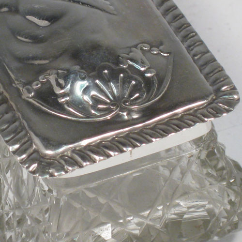 Antique Victorian sterling silver hand-chased and cut-crystal dressing table box made by the Deakin Brothers of Chester in 1901. Length 11 cms (4.25 inches), width 5 cms (2 inches), height 4.5 cms (1.75 inches).