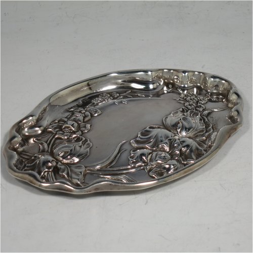 An Antique Edwardian Art Nouveau Sterling Silver small dressing table pin tray, having a shaped oval body with hand-chased floral decoration, a central vacant cartouche, and all sitting on a flat base. Made by Thomas Bishton of Birmingham in 1908. The dimensions of this fine hand-made antique silver pin tray are length 13.5 cms (5.3 inches), width 9.5 cms (3.75 inches), and it weighs approx. 47g (1.5 troy ounces).   