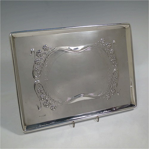 A very pretty Antique Edwardian Sterling Silver Art Nouveau style dressing table pin tray, having a rectangular body with hand-chased floral and ribbon work, a raised plain outer border, and all sitting on a flat base. Made by Charles H. Dumeril of London in 1907. The dimensions of this fine hand-made antique silver pin tray are length 32 cms (12.5 inches), width 23 cms (9 inches), and it weighs approx. 584g (18.8 troy ounces).    