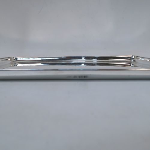 A very elegant Sterling Silver dressing table or pen  tray, having a rectangular body with a raised and applied reeded border and rounded corners, a plain ground, and all sitting on a flat base. This handsome dressing table or pen tray was made by the Adie Brothers of Birmingham in 1925. The dimensions of this fine hand-made silver pen or dressing table tray are length 28 cms (11 inches), width 21.5 cms (8.5 inches), and it weighs approx. 431g (14 troy ounces).   