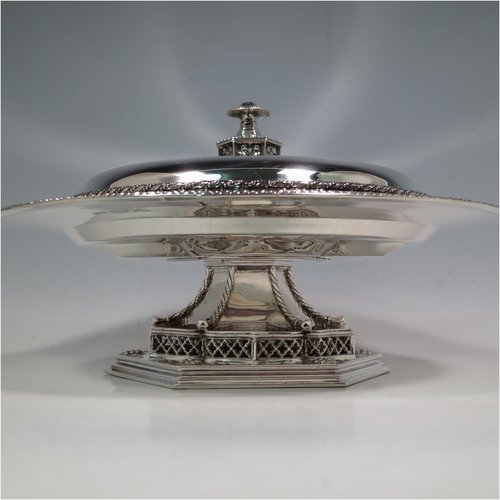 A rare and beautiful Antique Sterling Silver Arts and Crafts style altar Offertory dish and cover, having a round body with a lift off lid, sitting on a hexagonal foot with hand-pierced decoration, the lid with a matching cast finial, and with applied rope-twist borders. This elegant offertory dish and cover was made by Mappin & Webb of London in 1911. The dimensions of this fine hand-made antique silver offertory dish and cover are diameter 21 cms (8.25 inches), height 10 cms (4 inches), and it weighs approx. 872g (28 troy ounces).