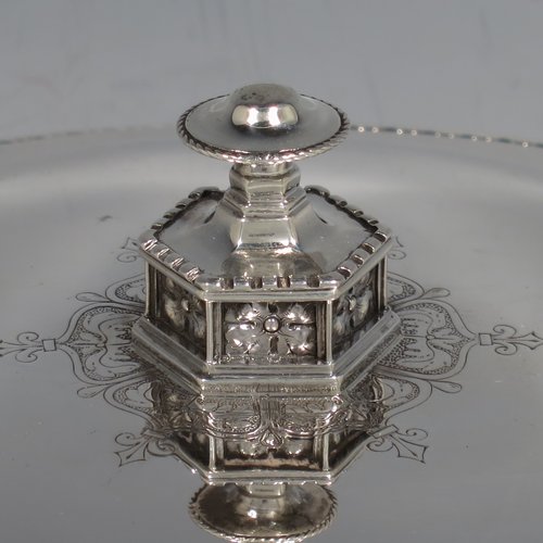 A rare and beautiful Antique Sterling Silver Arts and Crafts style altar Offertory dish and cover, having a round body with a lift off lid, sitting on a hexagonal foot with hand-pierced decoration, the lid with a matching cast finial, and with applied rope-twist borders. This elegant offertory dish and cover was made by Mappin & Webb of London in 1911. The dimensions of this fine hand-made antique silver offertory dish and cover are diameter 21 cms (8.25 inches), height 10 cms (4 inches), and it weighs approx. 872g (28 troy ounces).