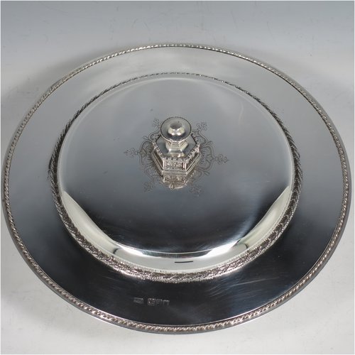 A rare and beautiful Antique Sterling Silver Arts and Crafts style altar Offertory dish and cover, having a round body with a lift off lid, sitting on a hexagonal foot with hand-pierced decoration, the lid with a matching cast finial, and with applied rope-twist borders. This elegant offertory dish and cover was made by Mappin & Webb of London in 1911. The dimensions of this fine hand-made antique silver offertory dish and cover are diameter 21 cms (8.25 inches), height 10 cms (4 inches), and it weighs approx. 872g (28 troy ounces).