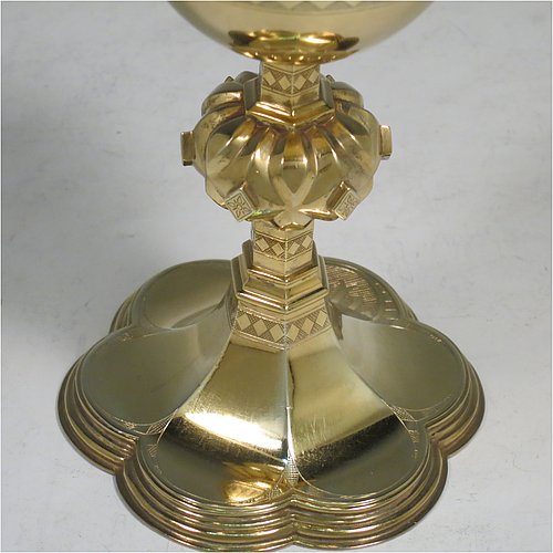 An Antique Victorian Sterling Silver and Gold Gilt small communion chalice, having a round cup with a hand-engraved band of diamond shapes, a middle baluster with hand-chased diamond shaped decoration, and all sitting on a spreading hexafoil foot engraved with a Christogram. Made by John Keith of London in 1855. The dimensions of this fine hand-made antique silver chalice are height 12.5 cms (5 inches), width at base 8 cms (3 inches), and it weighs approx. 125g (4 troy ounces).   