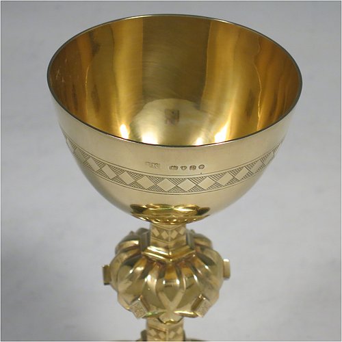 An Antique Victorian Sterling Silver and Gold Gilt small communion chalice, having a round cup with a hand-engraved band of diamond shapes, a middle baluster with hand-chased diamond shaped decoration, and all sitting on a spreading hexafoil foot engraved with a Christogram. Made by John Keith of London in 1855. The dimensions of this fine hand-made antique silver chalice are height 12.5 cms (5 inches), width at base 8 cms (3 inches), and it weighs approx. 125g (4 troy ounces).   