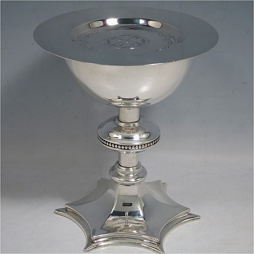 A Sterling Silver altar chalice and paten, having a plain round tapering cup with gold-gilt interior, a round column with a middle baluster and bead border, and a spreading hexagonal pedestal foot, together with a plain round paten with hand-engraved cross. The chalice made by Frederick Osborne of London in 1931, and the paten by Jones and Willis of London in 1908. The dimensions of this fine hand-made silver chalice & paten are height 15 cms (6 inches), diameter of cup 10 cms (4 inches), diameter of paten 13.5 cms (5.3 inches), and it weighs a total of 455g (14.7 troy ounces). 