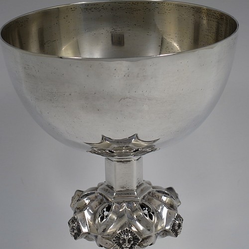 A large and heavy Antique Edwardian Sterling Silver altar chalice, having a plain round bellied cup, an octagonal column with middle baluster having hand-pierced decoration and applied leopards heads, and a spreading concave octagonal foot with a gadroon lower borer. Made by Frederick Wray of London in 1910. The dimensions of this fine hand-made antique silver altar chalice are height 20 cms (8 inches), diameter of cup 12cms (4.75 inches), across foot 16 cms (6.3 inches), and it weighs approx. 584g (18.8 troy ounces).    