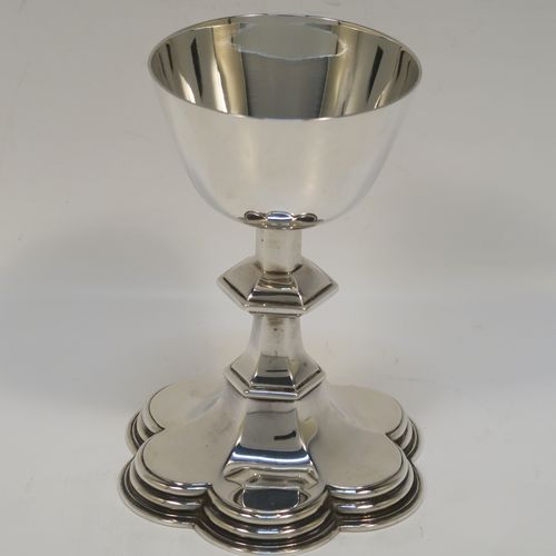 A very handsome Antique Sterling Silver altar chalice and paten, having a plain round tapering cup, a middle hexagonal baluster, sitting on a spreading hexafoil foot, and a plain round paten. The chalice was made by Goldsmiths and Silversmiths of London in 1914, and the paten was made by the Dixon Brothers of Sheffield in 1911. The dimensions of this fine hand-made antique silver chalice and paten are height of chalice 12.5 cms (5 inches), diameter of paten 12.5 cms (5 inches), and with a total weight of approx. 241g (7.8 troy ounces).   