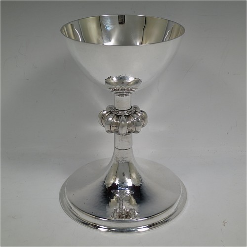 A large and handsome Sterling Silver altar chalice, having a round hand-hammered tapering cup, a middle hand-chased octagonal style baluster with upper and lower applied beaded bands, and a spreading pedestal foot, again hand-hammered and with an engraved Christ on the Cross. Made by A. R. Mowbray and Co., Ltd., of London in 1936. The dimensions of this fine hand-made silver chalice are height 20 cms (8 inches), diameter at base 15 cms (6 inches), and it weighs approx. 581g (18.7 troy ounces).    