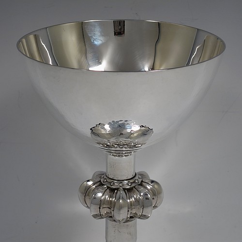 A large and handsome Sterling Silver altar chalice, having a round hand-hammered tapering cup, a middle hand-chased octagonal style baluster with upper and lower applied beaded bands, and a spreading pedestal foot, again hand-hammered and with an engraved Christ on the Cross. Made by A. R. Mowbray and Co., Ltd., of London in 1936. The dimensions of this fine hand-made silver chalice are height 20 cms (8 inches), diameter at base 15 cms (6 inches), and it weighs approx. 581g (18.7 troy ounces).    