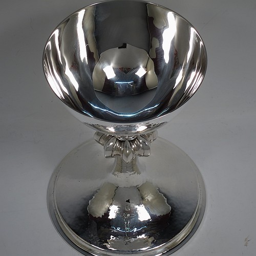 A large and handsome Sterling Silver altar chalice, having a round hand-hammered tapering cup, a middle hand-chased octagonal style baluster with upper and lower applied beaded bands, and a spreading pedestal foot, again hand-hammered and with an engraved Christ on the Cross. Made by A. R. Mowbray and Co., Ltd., of London in 1936. The dimensions of this fine hand-made silver chalice are height 20 cms (8 inches), diameter at base 15 cms (6 inches), and it weighs approx. 581g (18.7 troy ounces).    