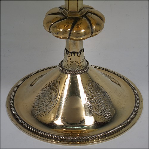 A very beautiful Sterling Silver and Gold-Gilt Ciborium, having a round body with a band of hand-engraved floral motifs, a plain round lift-off lid with cast cruciform finial, a hand-chased swirl-fluted central baluster, and all sitting on a round pedestal foot base with hand-engraved oval cartouches of wheat-sheaves and applied rope-twist borders. Made by Hayes and Finch Ltd., of London in 1951. The dimensions of this fine hand-made silver and gold-gilt ciborium are height 23.5 cms (9.25 inches), diameter of cup 12 cms (4.75 inches), and it weighs a total of approx. 730g (23.5 troy ounces).    