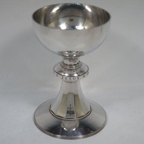 A very handsome Arts and Crafts style Sterling Silver altar chalice with a hand-hammered or plenished finish, having a plain round tapering bowl, a middle plain round baluster hand-engraved with the Latin Christogram Jesus Hominum Salvator (Jesus Saviour of Men), sitting on a round and panelled pedestal foot with a hand-engraved cross crucifix. Made by the Central School of Arts and Crafts of London in 1948. The dimensions of this fine hand-made silver chalice are height of chalice 15 cms (6 inches), diameter of foot 10 cms (4 inches), and it weighs of approx. 345g (11 troy ounces).    