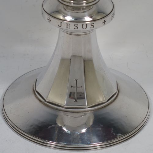 A very handsome Arts and Crafts style Sterling Silver altar chalice with a hand-hammered or plenished finish, having a plain round tapering bowl, a middle plain round baluster hand-engraved with the Latin Christogram Jesus Hominum Salvator (Jesus Saviour of Men), sitting on a round and panelled pedestal foot with a hand-engraved cross crucifix. Made by the Central School of Arts and Crafts of London in 1948. The dimensions of this fine hand-made silver chalice are height of chalice 15 cms (6 inches), diameter of foot 10 cms (4 inches), and it weighs of approx. 345g (11 troy ounces).    