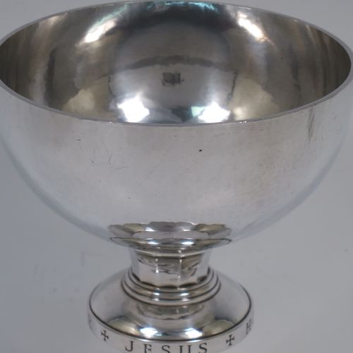 A very handsome Arts and Crafts style Sterling Silver altar chalice with a hand-hammered or plenished finish, having a plain round tapering bowl, a middle plain round baluster hand-engraved with the Latin Christogram Jesus Hominum Salvator (Jesus Saviour of Men), sitting on a round and panelled pedestal foot with a hand-engraved cross crucifix. Made by the Central School of Arts and Crafts of London in 1948. The dimensions of this fine hand-made silver chalice are height of chalice 15 cms (6 inches), diameter of foot 10 cms (4 inches), and it weighs of approx. 345g (11 troy ounces).    