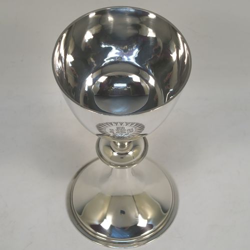 A handsome Antique Victorian Sterling Silver altar chalice, having a plain round tapering cup, a middle plain round stepped baluster, sitting on a round stepped pedestal foot. This beautiful silver chalice was made by Angel and Savory of London in 1894. The dimensions of this fine hand-made antique silver chalice are height 16 cms (6.3 inches), diameter at lip 8 cms (3.25 inches), and it weighs approx. 207g (6.7 troy ounces). Please note that this item has a contemporaneous inscription underneath. 