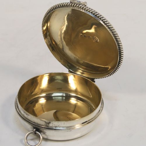 A large and handsome Sterling Silver Pyx box, having a round body with applied rope-twist borders, a hinged lid with a hand-engraved Christogram, a gold-gilt interior, and with a pair of ring handles. This elegant silver pyx box was made by A. R. Mowbray and Co. Ltd., of London in 1934. The dimensions of this fine hand-made large silver Pyx box are diameter 6.5 cms (2.5 inches), depth 2 cms (0.5 inches), and it weighs approx. 68g (2.2 troy ounces).   