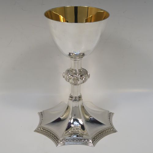 A large and handsome Sterling Silver altar chalice having a hand-hammered or planished finish, with  a round tapering cup and a gold-gilt interior, an octagonal panelled stem with a central applied jewel-like baluster, and all sitting on a spreading octagonal panelled base with an applied fleur-de-lis border. This beautiful and impressive silver altar chalice was made made by A. R. Mowbray and Co., Ltd., of London in 1948. The dimensions of this fine hand-made silver chalice are height 20 cms (8 inches), diameter at lip of cup 10 cms (4 inches), spread across base 15 cms (6 inches), and it weighs approx. 444g (14.3 troy ounces).   