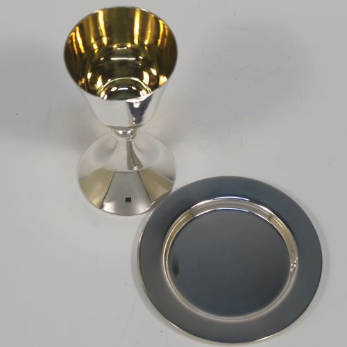 An elegant Antique Sterling Silver travelling communion chalice, having a plain round tapering cup with a gold-gilt interior, a round column with a middle baluster, and a spreading round pedestal foot, together with a matching plain round paten. The chalice was made by the Dixon Brothers of Sheffield in 1911, whilst the paten was made by A. E. Jones of Sheffield in 1962. The dimensions of this fine hand-made antique silver chalice & paten are height of chalice 12 cms (4.75 inches), diameter of paten 10 cms (4 inches), and the total weight is 137g (4.4 troy ounces).   