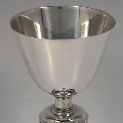 A pair of very handsome Sterling Silver altar chalices, having plain round tapering cups, with middle round balusters, and sitting on spreading hexafoil feet. This elegant pair of silver chalices were made by Blunt and Wray of London in 1928. The dimensions of these fine hand-made pair of silver chalices are height 16 cms (6.3 inches), diameter of cups at lip 8.5 cms (3.3 inches), and with a total weight of approx. 366g (11.8 troy ounces).  