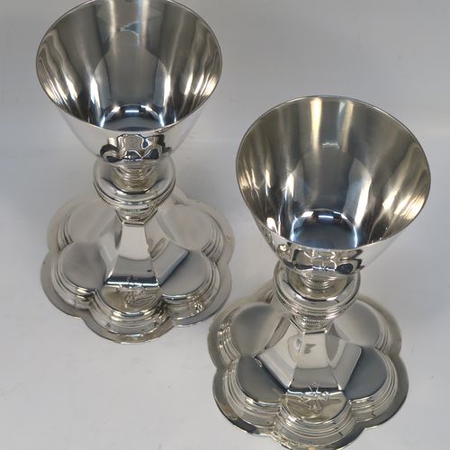 A pair of very handsome Sterling Silver altar chalices, having plain round tapering cups, with middle round balusters, and sitting on spreading hexafoil feet. This elegant pair of silver chalices were made by Blunt and Wray of London in 1928. The dimensions of these fine hand-made pair of silver chalices are height 16 cms (6.3 inches), diameter of cups at lip 8.5 cms (3.3 inches), and with a total weight of approx. 366g (11.8 troy ounces).  