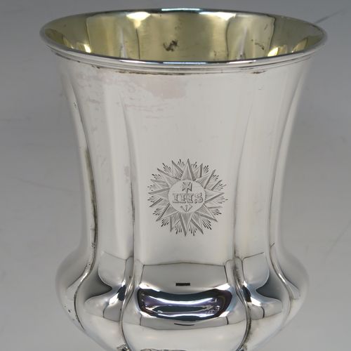 A large and very handsome Antique early Victorian Sterling Silver altar chalice, having a round bellied body with hand-chased melon fluting and a gold-gilt interior, and sitting on a spreading melon-fluted pedestal foot. This large and beautiful silver chalice was made by Henry Wilkinson of Sheffield in 1839. The dimensions of this fine hand-made antique silver altar chalice are height 23 cms (9 inches), diameter at lip 10 cms (4 inches), and it weighs approx. 435g (14 troy ounces). Please note that this item is engraved with a sun-burst Christogram.