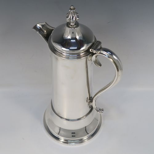 A handsome and large Antique Victorian Sterling Silver ecclesiastical wine flagon ewer, having a round straight-sided body with tapering sides and  applied reeded bands, a side scroll handle, together with a hinged domed lid and cast fluted finial, a sparrow-beak spout, and sitting on a spreading collet foot. This elegant silver church consecrated wine flagon was made by the Barnard Brothers of London in 1850. The dimensions of this fine hand-made antique silver flagon or ewer are height 34.5 cms (13.5 inches), diameter at base 14.5 cms (5.75 inches), and it weighs approx. 980g (31.6 troy ounces).   