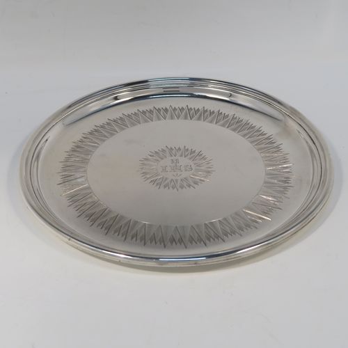 A very handsome Antique early Victorian Sterling Silver offertory or alms dish, having a round body, with an applied reeded border, a hand-engraved ground with sun-burst work surrounding a central Christogram, and all sitting on a flat base. This elegant antique silver alms or offertory dish was made by Henry Wilkinson of Sheffield in 1839. The dimensions of this fine hand-made silver offertory dish are diameter 23 cms (9 inches), and it weighs approx. 475g (15.3 troy ounces).   