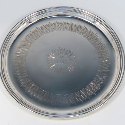 A very handsome Antique early Victorian Sterling Silver offertory or alms dish, having a round body, with an applied reeded border, a hand-engraved ground with sun-burst work surrounding a central Christogram, and all sitting on a flat base. This elegant antique silver alms or offertory dish was made by Henry Wilkinson of Sheffield in 1839. The dimensions of this fine hand-made silver offertory dish are diameter 23 cms (9 inches), and it weighs approx. 475g (15.3 troy ounces).   