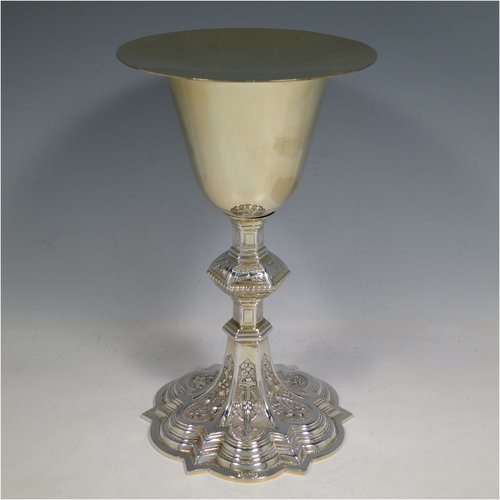 An Irish Sterling Silver altar chalice and paten, having a plain round tapering gold-gilt cup, a panelled column with a middle baluster, and a spreading pedestal foot, all hand-chased and engraved with floral & geometrical work, together with a plain round gold-gilt paten. Made by the same maker (J.S)  of Dublin in 1935/39. The dimensions of this fine hand-made silver chalice & paten are height 23 cms (9 inches), diameter at base 13.5 cms (5.3 inches), and it weighs approx. 607g (19.6 troy ounces). Please note that there is an inscription under the base.   