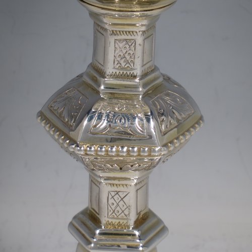 An Irish Sterling Silver altar chalice and paten, having a plain round tapering gold-gilt cup, a panelled column with a middle baluster, and a spreading pedestal foot, all hand-chased and engraved with floral & geometrical work, together with a plain round gold-gilt paten. Made by the same maker (J.S)  of Dublin in 1935/39. The dimensions of this fine hand-made silver chalice & paten are height 23 cms (9 inches), diameter at base 13.5 cms (5.3 inches), and it weighs approx. 607g (19.6 troy ounces). Please note that there is an inscription under the base.   