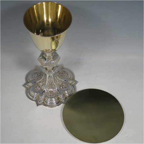 An Irish Sterling Silver altar chalice and paten, having a plain round tapering gold-gilt cup, a panelled column with a middle baluster, and a spreading pedestal foot, all hand-chased and engraved with floral & geometrical work, together with a plain round gold-gilt paten. Made by the same maker (J.S)  of Dublin in 1935/39. The dimensions of this fine hand-made silver chalice & paten are height 23 cms (9 inches), diameter at base 13.5 cms (5.3 inches), and it weighs approx. 607g (19.6 troy ounces). Please note that there is an inscription under the base.   