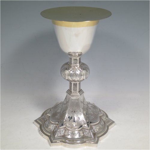 An Antique Victorian Irish Sterling Silver altar chalice and paten, having a plain round tapering cup with gold-gilt interior, a panelled column with a middle baluster, and a spreading pedestal foot, all hand-chased and engraved with floral & geometrical work, together with a plain round gold-gilt paten. Made by Samuel Le Bass of Dublin in 1863/64. The dimensions of this fine hand-made antique silver chalice & paten are height 21.5 cms (8.5 inches), diameter at base 15 cms (6 inches), and it weighs approx. 395g (12.7 troy ounces).   