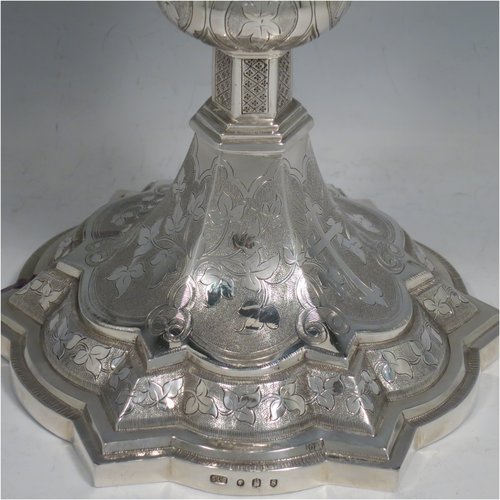 An Antique Victorian Irish Sterling Silver altar chalice and paten, having a plain round tapering cup with gold-gilt interior, a panelled column with a middle baluster, and a spreading pedestal foot, all hand-chased and engraved with floral & geometrical work, together with a plain round gold-gilt paten. Made by Samuel Le Bass of Dublin in 1863/64. The dimensions of this fine hand-made antique silver chalice & paten are height 21.5 cms (8.5 inches), diameter at base 15 cms (6 inches), and it weighs approx. 395g (12.7 troy ounces).   