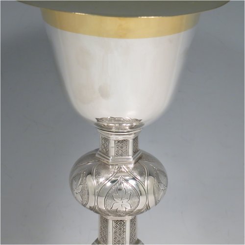 An Antique Victorian Irish Sterling Silver altar chalice and paten, having a plain round tapering cup with gold-gilt interior, a panelled column with a middle baluster, and a spreading pedestal foot, all hand-chased and engraved with floral & geometrical work, together with a plain round gold-gilt paten. Made by Samuel Le Bass of Dublin in 1863/64. The dimensions of this fine hand-made antique silver chalice & paten are height 21.5 cms (8.5 inches), diameter at base 15 cms (6 inches), and it weighs approx. 395g (12.7 troy ounces).   