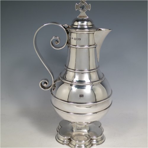 An Antique Edwardian Sterling Silver ecclesiastical wine / water flagon, having a plain baluster body with applied bands, together with a hinged domed lid with a Celtic style cross finial, a plain sparrow-beak spout, a scroll handle, and sitting on a spreading hexafoil foot. Made by Robert Stebbings of London in 1905. The dimensions of this fine hand-made antique silver flagon are height 31 cms (12.25 inches), length 16 cms (6.25 inches), and it weighs approx. 897g (29 troy ounces).   