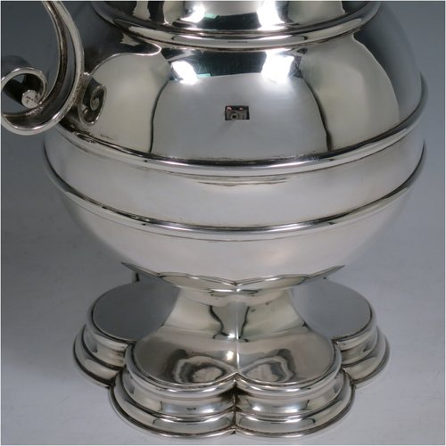 An Antique Edwardian Sterling Silver ecclesiastical wine / water flagon, having a plain baluster body with applied bands, together with a hinged domed lid with a Celtic style cross finial, a plain sparrow-beak spout, a scroll handle, and sitting on a spreading hexafoil foot. Made by Robert Stebbings of London in 1905. The dimensions of this fine hand-made antique silver flagon are height 31 cms (12.25 inches), length 16 cms (6.25 inches), and it weighs approx. 897g (29 troy ounces).   