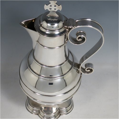 An Antique Edwardian Sterling Silver ecclesiastical wine / water flagon, having a plain baluster body with applied bands, together with a hinged domed lid with a Celtic style cross finial, a plain sparrow-beak spout, a scroll handle, and sitting on a spreading hexafoil foot. Made by Robert Stebbings of London in 1905. The dimensions of this fine hand-made antique silver flagon are height 31 cms (12.25 inches), length 16 cms (6.25 inches), and it weighs approx. 897g (29 troy ounces).   