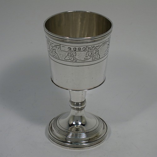 An Antique Georgian Sterling Silver small travelling communion chalice with reeded borders, having a round cup with tapering sides and a hand-engraved upper band of grape-vine decoration, a middle baluster with an applied reeded band, and sitting on a round pedestal foot. Made by Thomas Wallis II and Jonathan Hayne of London in 1812. The dimensions of this fine hand-made antique silver travelling communion chalice are height 10 cms (4 inches), diameter at lip 5 cms (2 inches), and it weighs approx. 84g (2.7 troy ounces).    