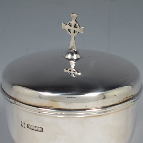 A Scottish Sterling Silver Ciborium, having a plain round body, sitting on a matching pedestal foot with applied reeded borders, and a lift-off lid with cruciform finial. Made by H. D. Falconer & Son of Glasgow in 1945. The dimensions of this fine hand-made silver ciborium are height 22 cms (8.75 inches), diameter of cup 11 cms (4.25 inches), and it weighs a total of approx. 530g (17 troy ounces).   