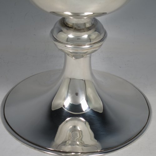 A Scottish Sterling Silver Ciborium, having a plain round body, sitting on a matching pedestal foot with applied reeded borders, and a lift-off lid with cruciform finial. Made by H. D. Falconer & Son of Glasgow in 1945. The dimensions of this fine hand-made silver ciborium are height 22 cms (8.75 inches), diameter of cup 11 cms (4.25 inches), and it weighs a total of approx. 530g (17 troy ounces).   