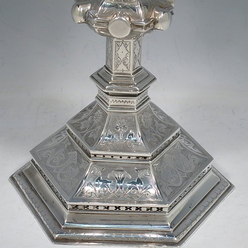 An Antique Victorian Sterling Silver large altar chalice, having a plain round cup with tapering sides and gold-gilt interior, an octagonal column with middle baluster and engraved panels, and a spreading octagonal foot with hand-pierced borders and hand-engraved floral and scroll decoration. Made by Robert Stebbings of London in 1885. The dimensions of this fine hand-made antique silver altar chalice are height 24 cms (9.5 inches), width at base 12.5 cms (5 inches), and it weighs approx. 453g (14.6 troy ounces).   