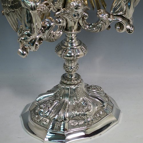 An Antique Victorian Sterling Silver and gold-gilt Belgian Monstrance, for holding the consecrated host, with crown finial above two cast cherub figures, a sun-burst relic Luna holder with two cast angel figures below, and sitting on a hand-chased oval shaped pedestal foot. Made by M. Decury of Belgium between 1831 and 1868. The dimensions of this fine hand-made antique silver Monstrance are height 71 cms (28 inches), depth 15 cms (6 inches), and width 33 cms (13 inches), with a total weight of approx. 97 troy ounces (3,000g).   