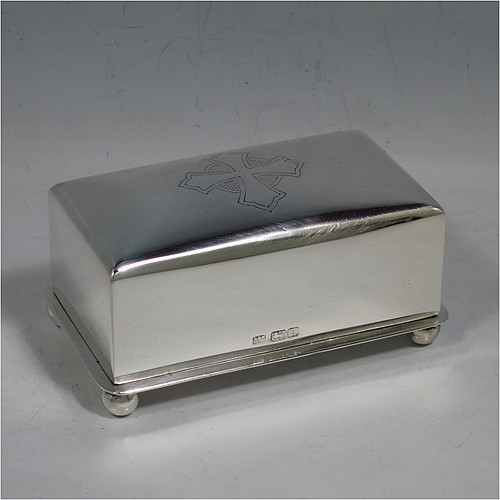 A Sterling Silver wafer box, having a plain rectangular body with rounded corners, a lift-off lid with a hand-engraved Christogram, covering a holder with five slots for wafers, and sitting on an applied base with four ball feet. Made by A. R. Mowbray & Co. Ltd., of London in 1946. The dimensions of this fine hand-made silver wafer box are length 9.5 cms (3.75 inches), depth 6 cms (2.25 inches), height 4.5 cms (1.75 inches), and it weighs approx. 211g (6.8 troy ounces).    