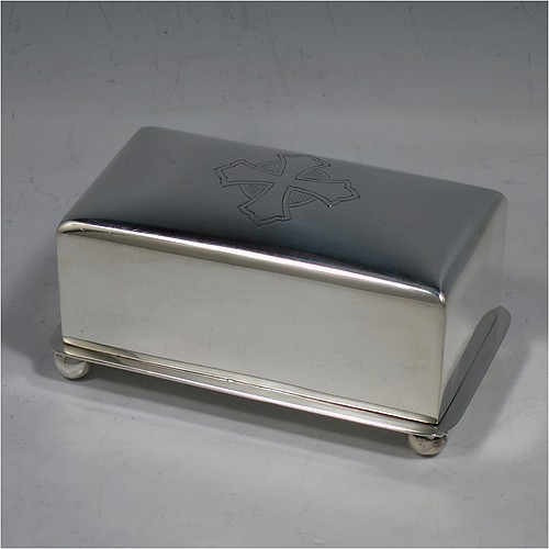 A Sterling Silver wafer box, having a plain rectangular body with rounded corners, a lift-off lid with a hand-engraved Christogram, covering a holder with five slots for wafers, and sitting on an applied base with four ball feet. Made by A. R. Mowbray & Co. Ltd., of London in 1946. The dimensions of this fine hand-made silver wafer box are length 9.5 cms (3.75 inches), depth 6 cms (2.25 inches), height 4.5 cms (1.75 inches), and it weighs approx. 211g (6.8 troy ounces).    